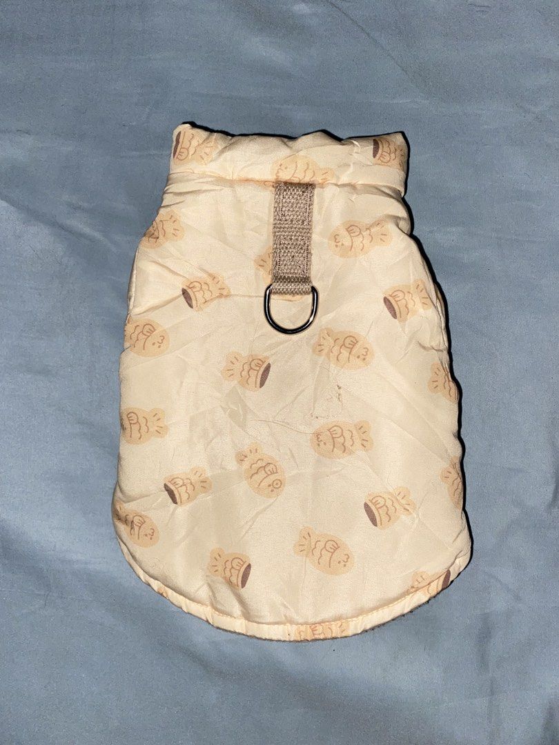 Cute Fish Pattern Dog Puffer Jacket with Leash Ring (Category: Homes & Other Pet Accessories) located in Binan City. Submitted by angelenecuis (Listing ID 1459269482, Image 2). Description: Size: XS-Small - Adorable cream-colored dog puffer jacket featuring a cute fish pattern. - Lined with soft fleece for ultimate warmth and comfort. - Convenient built-in leash ring on the back for easy walks. - Simple and secure snap button closure for hassle-f