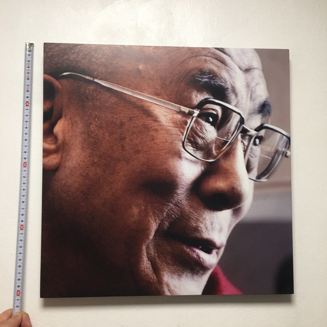 Dalai Lama Portrait Wall Art Print (Category: Wall Decor) located in Pasay City. Submitted by gilbertso62551 (Listing ID 1459207436, Image 2). Description: - Square print featuring a close-up portrait of the Dalai Lama wearing glasses. - Back shows a wooden panel with markings: '23 / 4 / 07'. - Approximate dimensions: 12 inches by 12 inches. - Ideal for adding a unique touch to your home or office. - As is,where is - No frame - Minimal issues las