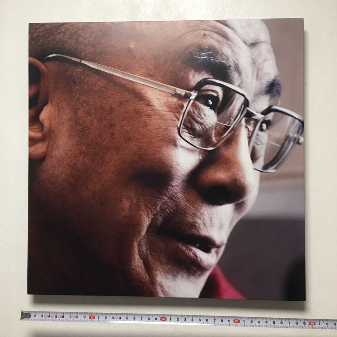 Dalai Lama Portrait Wall Art Print (Category: Wall Decor) located in Pasay City. Submitted by gilbertso62551 (Listing ID 1459207436, Image 3). Description: - Square print featuring a close-up portrait of the Dalai Lama wearing glasses. - Back shows a wooden panel with markings: '23 / 4 / 07'. - Approximate dimensions: 12 inches by 12 inches. - Ideal for adding a unique touch to your home or office. - As is,where is - No frame - Minimal issues las