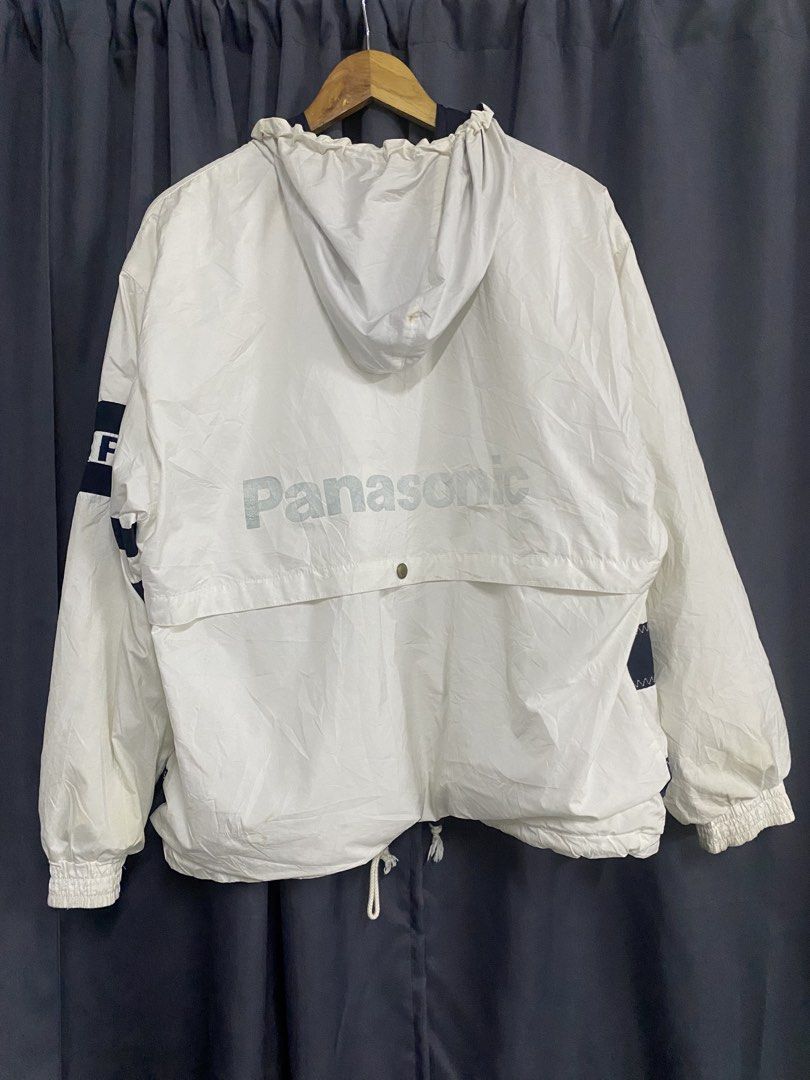 Fred Perry x Panasonic Windbreaker Jacket (Category: Coats, Jackets and Outerwear) located in Santa Maria. Submitted by saintarchive316 (Listing ID 1459192753, Image 2). Description: - White windbreaker jacket with navy blue accents - Features the iconic Fred Perry laurel wreath logo on the front - 'Panasonic' logo prominently displayed on the back - 'FRED PERRY' text printed on the left sleeve - Adjustable drawstring hem and hood for a customize