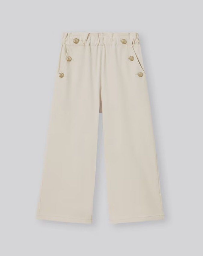 Gu Cream Wide Leg Pants (Category: Other Bottoms) located in Manila. Submitted by itsarah (Listing ID 1457605560, Image 1). Description: - Cream colored wide leg pants - High waisted with smocked back for a comfortable fit - Decorative gold buttons down the front for a touch of elegance - Wide leg silhouette for a stylish and flattering look - Perfect for dressing up or down, offering both comfort and style.