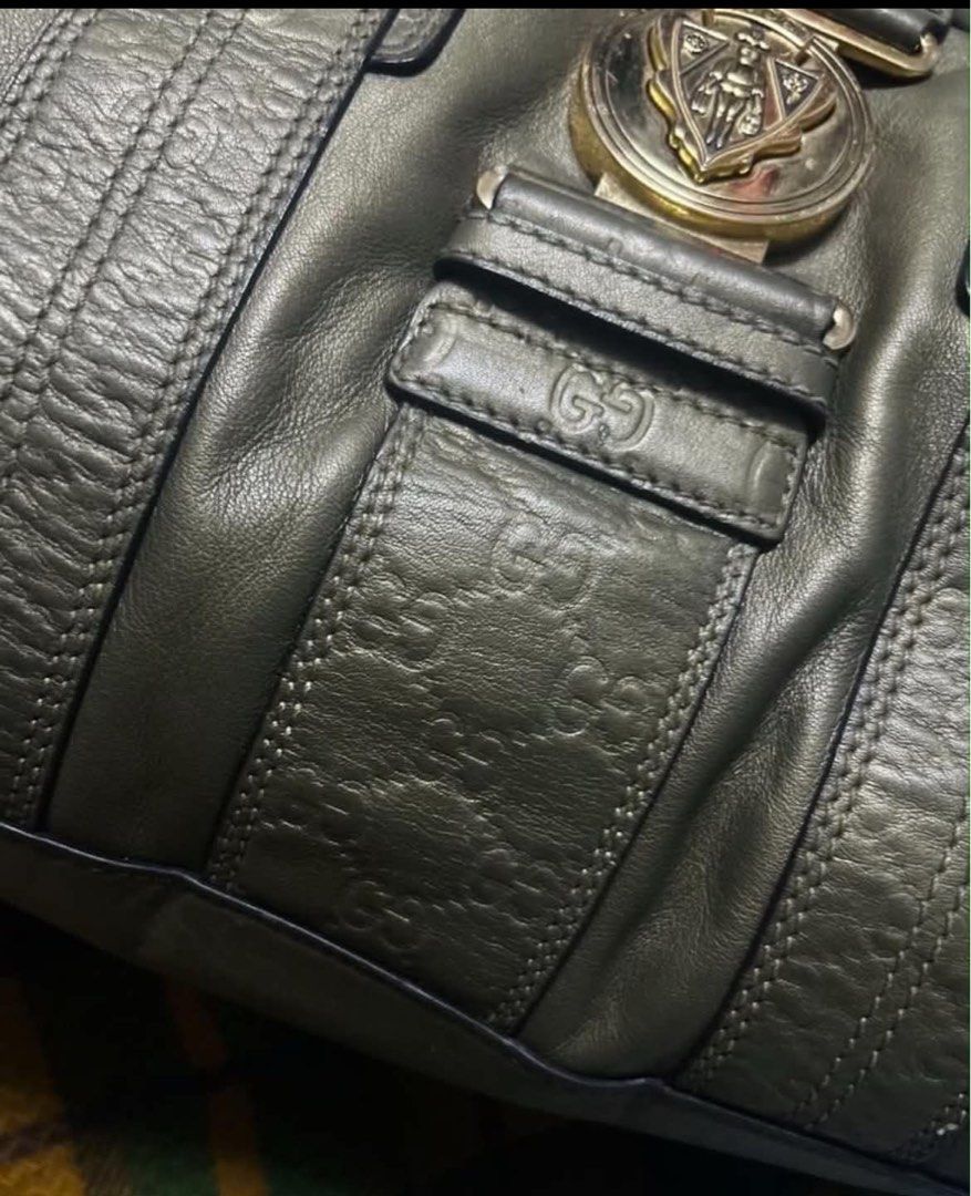 GUCCI (Category: Luxury Bags & Wallets) located in Davao. Submitted by sart0ria85 (Listing ID 1459134110, Image 3). Description: This is an olive green Gucci Guccissima Leather Aviatrix Boston bag, featuring the signature debossed GG monogram and a prominent gold-tone crest push-lock emblem on the front. Designed by Frida Gianini in 2011. Medium size duffle bag. With serial. .
