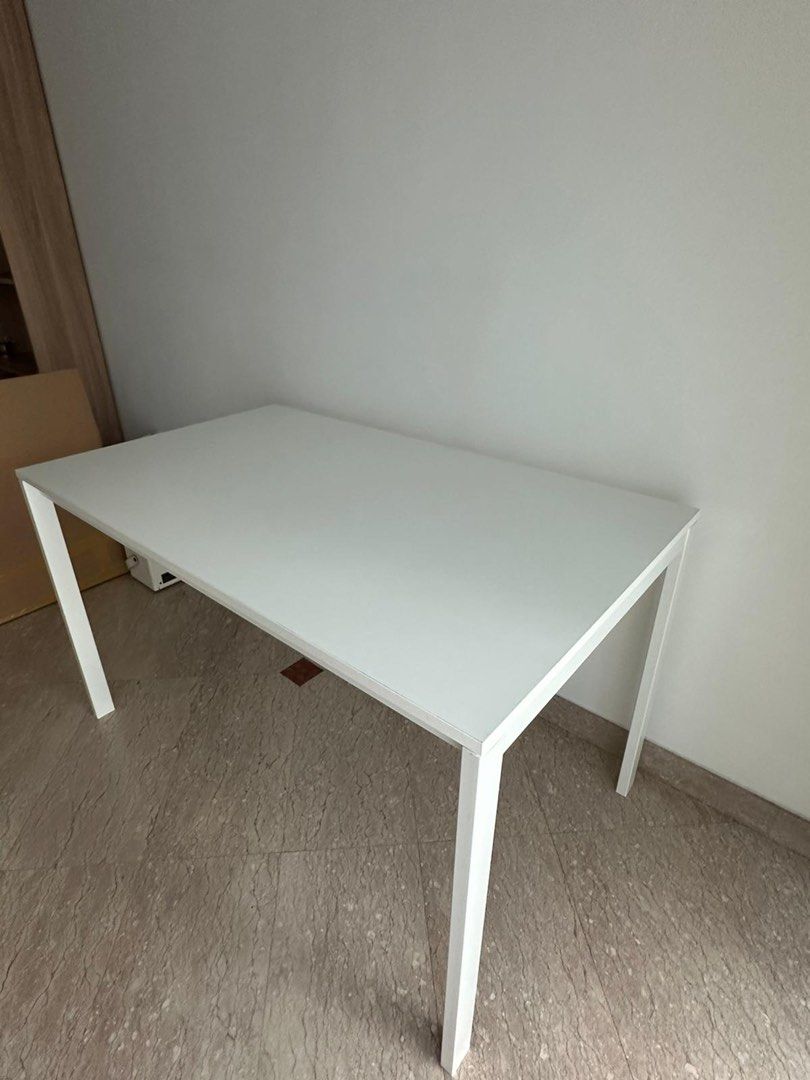 IKEA White Rectangular Dining Table Study Table (Category: Tables & Sets) located in Singapore. Submitted by chifanle (Listing ID 1459117895, Image 1). Description: - Versatile white table - Perfect for dining or as a work desk - Comfortably seats up to 4 people - Easy-to-clean surface - Sturdy and stable legs - Fits well in most room sizes - Selling due to relocation.