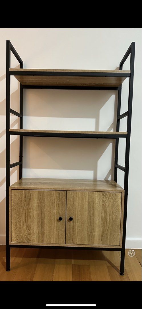 Industrial Style Bookshelf with Cabinet (Category: Shelves, Cabinets & Racks) located in Mandaluyong City. Submitted by fayeamante (Listing ID 1459102882, Image 1). Description: - Modern industrial design bookshelf - Sturdy construction - Two open shelves for display - Lower cabinet with double doors for concealed storage - Black metal frame - Wood-effect shelves and cabinet - Ideal for living rooms, studies, or bedrooms - Great for organizing bo