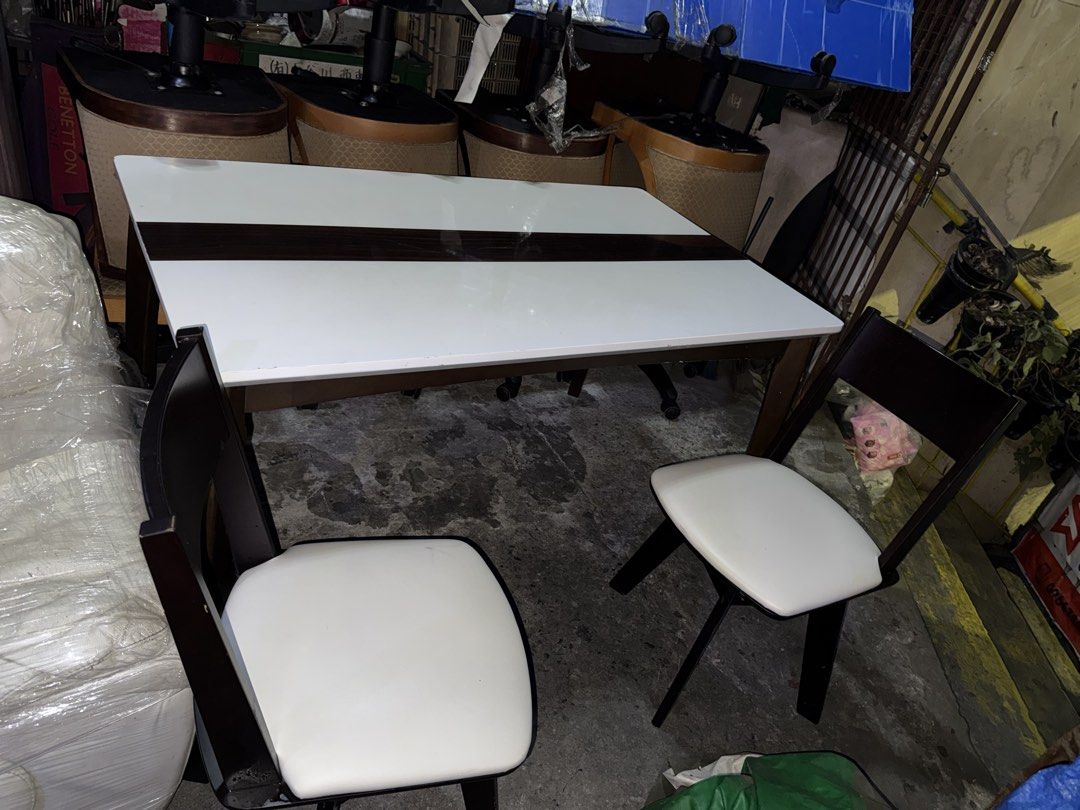 Japan Table Solid Wood Dining Set with 4 swivel Chairs (Category: Tables & Sets) located in Quezon City. Submitted by mikesiawingco (Listing ID 1459204829, Image 3). Description: - Complete dining set: 1 table + 4swivel chairs - Table: Solid wood, white top, dark wood accents - Chairs: Dark wood frames, white cushioned seats - Ideal for small dining areas - Table Dimensions: H 28 inches, L 53 inches, W 32 inches.