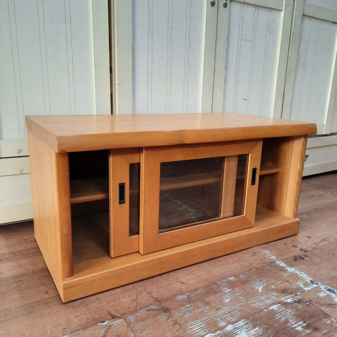 Karimoku Solid Wood Low-Profile TV Stand with Sliding Doors (Category: TV Consoles) located in Manila. Submitted by ivan_furnitures421 (Listing ID 1459231449, Image 3). Description: - Karimoku low-profile solid wood TV stand/media console - Space-saving double sliding door design - Dimensions: L90cm x W45cm x H44cm - Ideal for organizing media devices and accessories - Adds functional style to your living room.