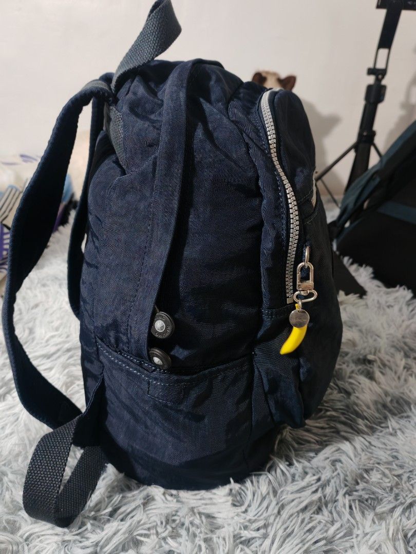 Kipling Navy Blue Nylon Mini Backpack (Category: Backpacks) located in Manila. Submitted by camellesal67218 (Listing ID 1459107065, Image 3). Description: - Navy blue Kipling mini backpack - Made of durable crinkled nylon - Front zipper pocket for quick access - Main compartment with an internal slip pocket - Adjustable shoulder straps for a comfortable fit - Adorable yellow banana zipper charm - Ideal for everyday adventures and essentials.