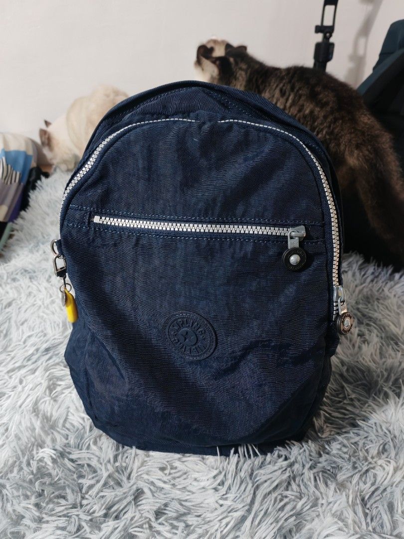 Kipling Navy Blue Nylon Mini Backpack (Category: Backpacks) located in Manila. Submitted by camellesal67218 (Listing ID 1459107065, Image 1). Description: - Navy blue Kipling mini backpack - Made of durable crinkled nylon - Front zipper pocket for quick access - Main compartment with an internal slip pocket - Adjustable shoulder straps for a comfortable fit - Adorable yellow banana zipper charm - Ideal for everyday adventures and essentials.