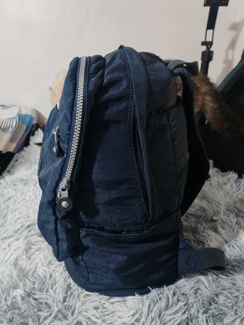 Kipling Navy Blue Nylon Mini Backpack (Category: Backpacks) located in Manila. Submitted by camellesal67218 (Listing ID 1459107065, Image 2). Description: - Navy blue Kipling mini backpack - Made of durable crinkled nylon - Front zipper pocket for quick access - Main compartment with an internal slip pocket - Adjustable shoulder straps for a comfortable fit - Adorable yellow banana zipper charm - Ideal for everyday adventures and essentials.
