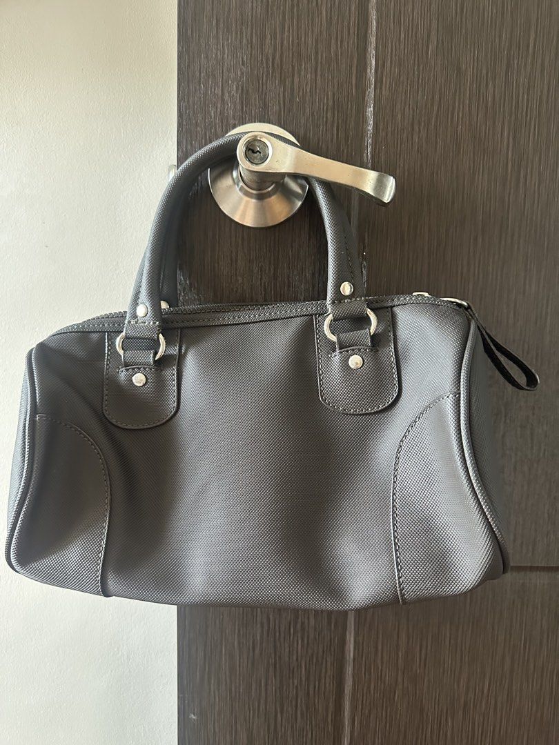 Lacoste Dark Grey Textured Boston Bag (Category: Luxury Bags & Wallets) located in Manila. Submitted by amazingamie8 (Listing ID 1459108268, Image 2). Description: - Dark grey Lacoste boston bag - Textured material - Zipper closure with cute Lacoste zipper pull - Interior zippered pocket - Sturdy handles - Great for everyday use.