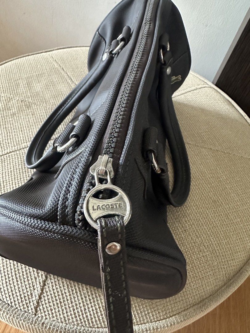 Lacoste Dark Grey Textured Boston Bag (Category: Luxury Bags & Wallets) located in Manila. Submitted by amazingamie8 (Listing ID 1459108268, Image 3). Description: - Dark grey Lacoste boston bag - Textured material - Zipper closure with cute Lacoste zipper pull - Interior zippered pocket - Sturdy handles - Great for everyday use.