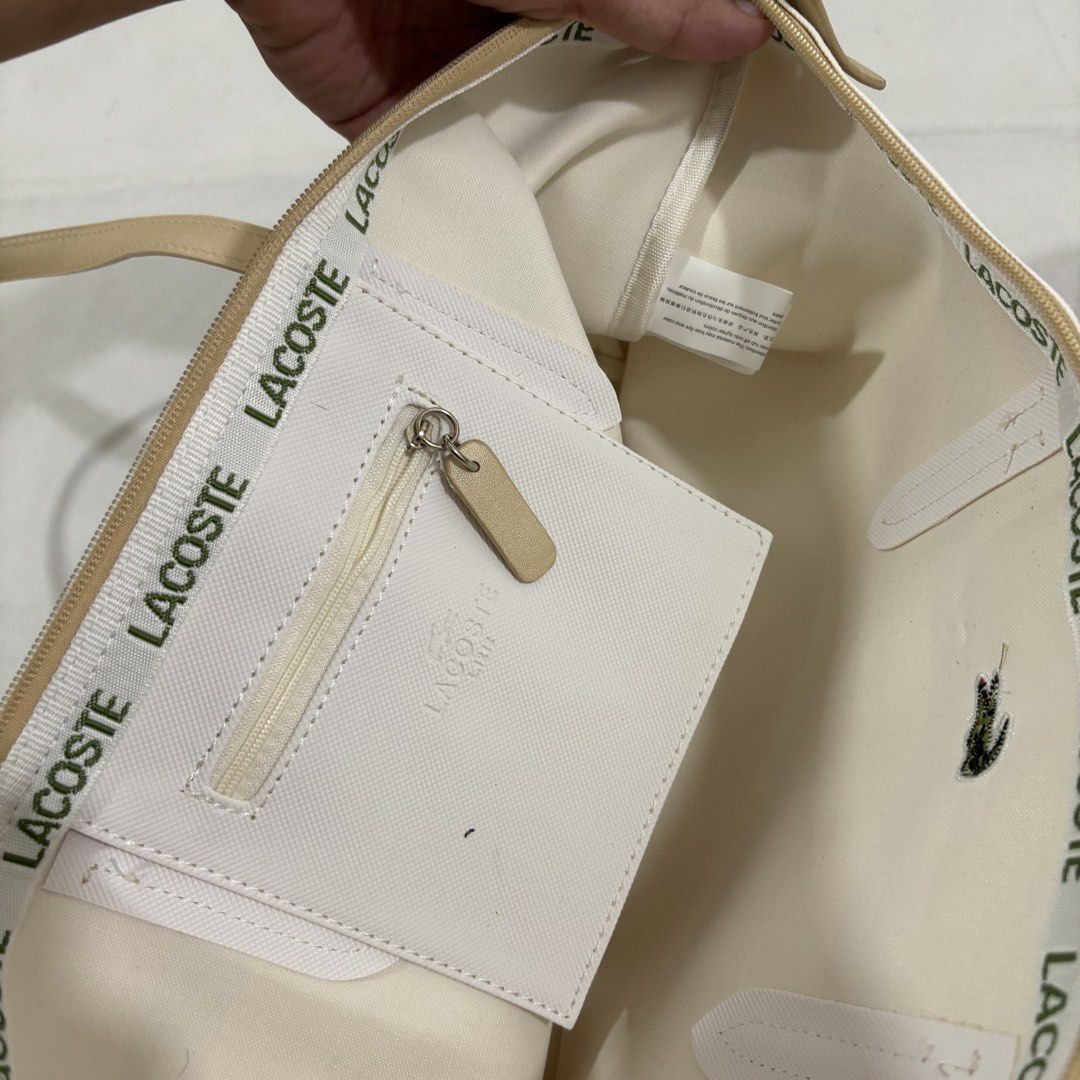 Lacoste Tote Bag - Striped Canvas (Category: Tote Bags) located in Cavite. Submitted by itsayaaa (Listing ID 1459045735, Image 3). Description: - Classic Lacoste tote bag - Horizontal stripes: tan, white, black - Tan leather handles and trim - Zipper closure - Embroidered Lacoste crocodile logo on front - Spacious interior - Ideal for everyday use.