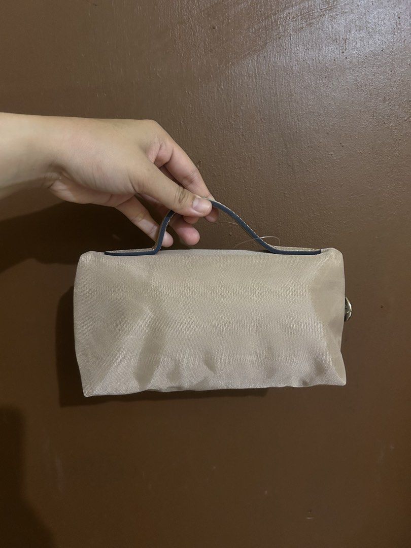 Longchamp Small (Category: Luxury Bags & Wallets) located in Paranaque City. Submitted by closetbychiph (Listing ID 1453998772, Image 2). Description: Brand: Longchamp Color: Beige / Nude Size: Small – perfect for essentials Material: Lightweight nylon with leather trim Closure: Zipper Detail: Iconic Longchamp horse logo Condition: Brand New Clean inside and out No major flaws Inclusions: Original dust bag Packaging Perfect for: Makeup / kikay ki