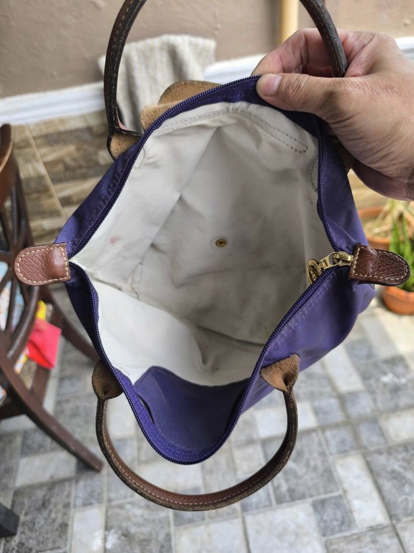 Longchamp Le Pliage Tote Bag (Category: Luxury Bags & Wallets) located in Caloocan City. Submitted by chefems0721 (Listing ID 1459208932, Image 2). Description: - Authentic Longchamp tote bag - Color: Purple and Mustard - Material: Leather handles and trim - Closure: Zipper - Interior: Some marks present - Features: Folds flat for storage - Ideal for: Everyday use - 1K each.