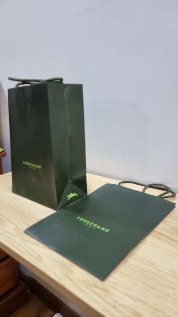 Longchamp Paris Shopping Bags (Category: Luxury Bags & Wallets) located in Paranaque City. Submitted by olxph_668280920 (Listing ID 1459225661, Image 3). Description: - Longchamp Paris paper shopping bags - Color: Dark green with lighter green logo - Sizes: One tall bag, one smaller/flatter bag - Ideal for gifting or storing small items - Bags are clean and ready for a new owner price per piece.