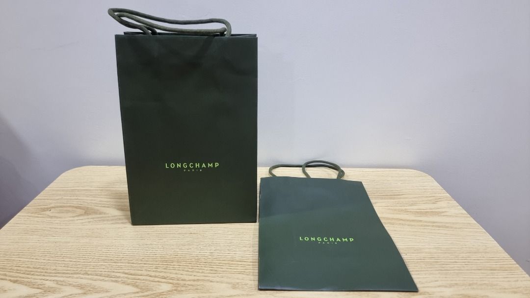 Longchamp Paris Shopping Bags (Category: Luxury Bags & Wallets) located in Paranaque City. Submitted by olxph_668280920 (Listing ID 1459225661, Image 1). Description: - Longchamp Paris paper shopping bags - Color: Dark green with lighter green logo - Sizes: One tall bag, one smaller/flatter bag - Ideal for gifting or storing small items - Bags are clean and ready for a new owner price per piece.