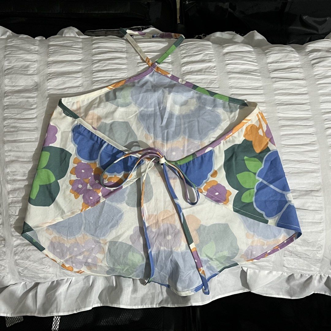 Love, Ara Floral Halter Neck Top (Category: Sleeveless) located in Manila. Submitted by love.kyrst (Listing ID 1459261749, Image 2). Description: - Brand: Love, Ara - Style: Halter neck top - Size: XS-Med - Design: Vibrant floral print with blue, purple, and orange flowers - Features: Ties at the back for an adjustable fit - Occasion: Ideal for casual day outs or beach trips.