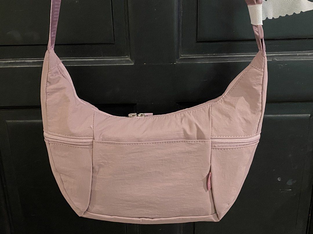Lululemon Bag - Lilac (Category: Cross-body Bags) located in Muntinlupa City. Submitted by mj.finds (Listing ID 1459205720, Image 2). Description: - Lululemon Bag - Size: Large - Color: Lilac - Material: Recycled Polyester - Features: Zippered pockets, adjustable strap - Origin: Designed in Vancouver, Made in Indonesia - Ideal for: Everyday use.