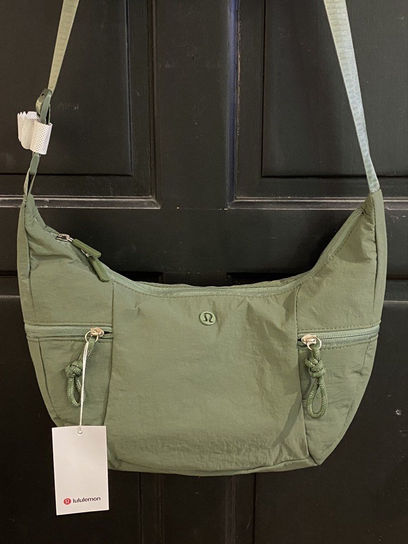 Lululemon Bag - Olive Green (Category: Cross-body Bags) located in Muntinlupa City. Submitted by mj.finds (Listing ID 1459208394, Image 1). Description: - Olive Green Lululemon Everywhere Bag - Made with durable, water-repellent fabric - Features a secure zippered main compartment and front pocket - Adjustable strap for comfortable, customized wear - Ideal for everyday errands, travel, and workouts - Comes with original Lululemon tags attached.
