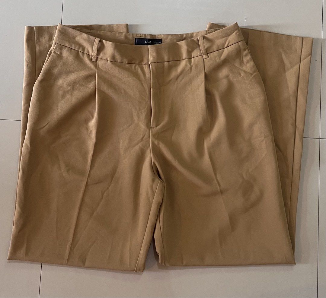 Mango Pleated Wide-Leg Trousers (Camel) (Category: Other Bottoms) located in Malay. Submitted by spacetrips (Listing ID 1459115660, Image 3). Description: Super chic and effortless tailored wide-leg pants from Mango in a gorgeous neutral camel tone. Features classic front pleats, side pockets, belt loops, and a hidden zip/hook closure. Flattering high/mid-rise fit that drapes perfectly. Super versatile—dress them up for the office with a blazer o