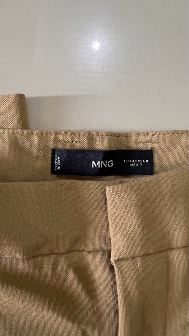Mango Pleated Wide-Leg Trousers (Camel) (Category: Other Bottoms) located in Malay. Submitted by spacetrips (Listing ID 1459115660, Image 2). Description: Super chic and effortless tailored wide-leg pants from Mango in a gorgeous neutral camel tone. Features classic front pleats, side pockets, belt loops, and a hidden zip/hook closure. Flattering high/mid-rise fit that drapes perfectly. Super versatile—dress them up for the office with a blazer o