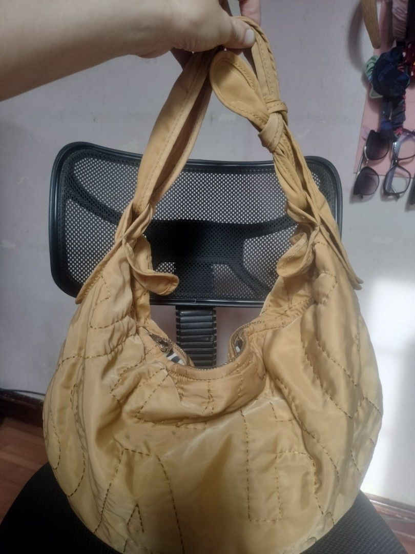 Marc by Marc Jacobs Quilted Hobo Bag (Category: Luxury Bags & Wallets) located in Cavite. Submitted by annasoriano1982 (Listing ID 1459089523, Image 2). Description: Marc by Marc Jacobs quilted hobo bag (Standard Supply). Features a teddy bear patch, star detail, and zipper closure. Knotted straps, spacious interior. Perfect for daily use. mustard color very nice hobo rare to find marami kang malalagay na gamit.