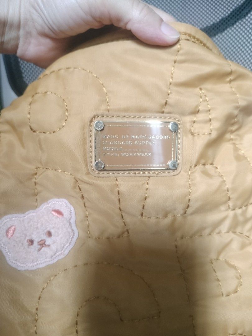 Marc by Marc Jacobs Quilted Hobo Bag (Category: Luxury Bags & Wallets) located in Cavite. Submitted by annasoriano1982 (Listing ID 1459089523, Image 3). Description: Marc by Marc Jacobs quilted hobo bag (Standard Supply). Features a teddy bear patch, star detail, and zipper closure. Knotted straps, spacious interior. Perfect for daily use. mustard color very nice hobo rare to find marami kang malalagay na gamit.
