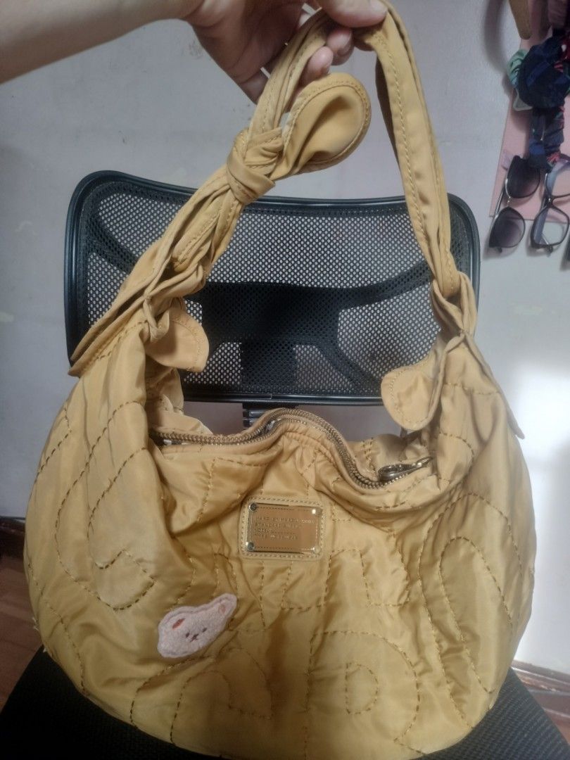 Marc by Marc Jacobs Quilted Hobo Bag (Category: Luxury Bags & Wallets) located in Cavite. Submitted by annasoriano1982 (Listing ID 1459089523, Image 1). Description: Marc by Marc Jacobs quilted hobo bag (Standard Supply). Features a teddy bear patch, star detail, and zipper closure. Knotted straps, spacious interior. Perfect for daily use. mustard color very nice hobo rare to find marami kang malalagay na gamit.