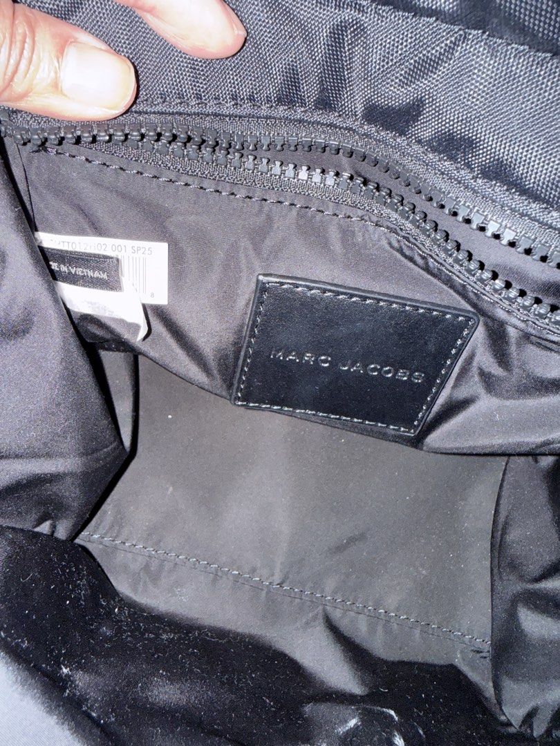 Marc Jacobs The Tote Bag Black Nylon (Category: Luxury Bags & Wallets) located in Cebu City. Submitted by adrieyen (Listing ID 1459277902, Image 3). Description: - Authentic Black Marc Jacobs Standard Supply Tote Bag - Ideal for Workwear - Features Top Handles and a Detachable Crossbody Strap - Includes an Interior Zipper Pocket - Made in Vietnam - Comes with Original Tags.