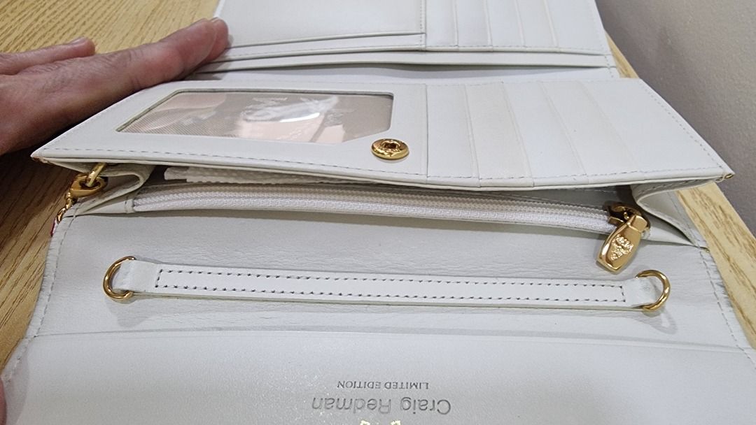 MCM Craig Redman Limited Edition Wallet (Category: Luxury Bags & Wallets) located in Paranaque City. Submitted by olxph_668280920 (Listing ID 1459218120, Image 3). Description: - Authentic MCM x Craig Redman collaboration wallet. - Iconic MCM logo print with unique rope and leaf pattern. - White textured leather detailing on the sides. - Elegant gold hardware and a charming anchor accent. - Interior features multiple card slots and a secure zippe