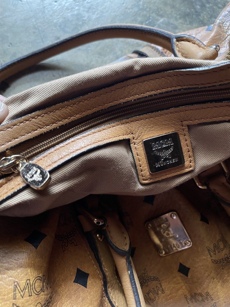 MCM Monogram Leather Duffle Bag (Category: Luxury Bags & Wallets) located in M'Lang. Submitted by thriftnikulot1.0 (Listing ID 1459109538, Image 3). Description: - Authentic MCM duffle bag - Classic all-over monogram print - Genuine leather handles and trim - Secure zipper closure - Interior zip pocket and MCM logo plate - Shows some signs of wear on leather and hardware - Perfect for travel or everyday use.