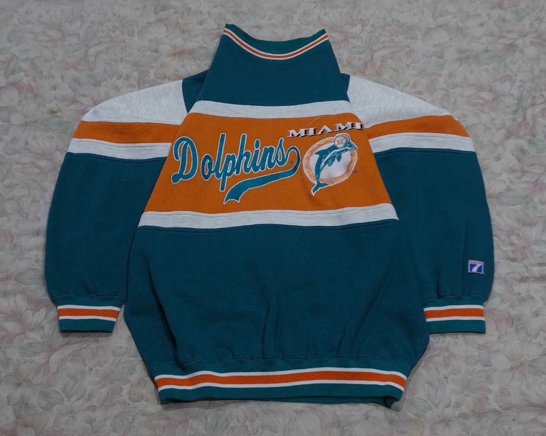 Miami Dolphins Sweatshirt (Category: Coats, Jackets and Outerwear) located in Naga. Submitted by makuri_4400 (Listing ID 1459140025, Image 1). Description: Size - L Length - 26.5 Width - 23.5 Condition - 9.5/10 Color rate - 8.5/10 Issue -Loose embroidery and stitching.