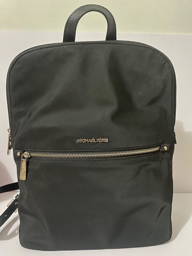 Michael Kors Black Nylon Backpack (Category: Backpacks) located in Caloocan City. Submitted by wrenessie (Listing ID 1459230141, Image 1). Description: - Brand: Authentic Michael Kors - Color: Black - Material: Nylon with leather trim - Closure: Zipper - Features: Adjustable straps, front zipper pocket - Condition: Clean inside and out - Ideal for: Everyday use - No flaws.