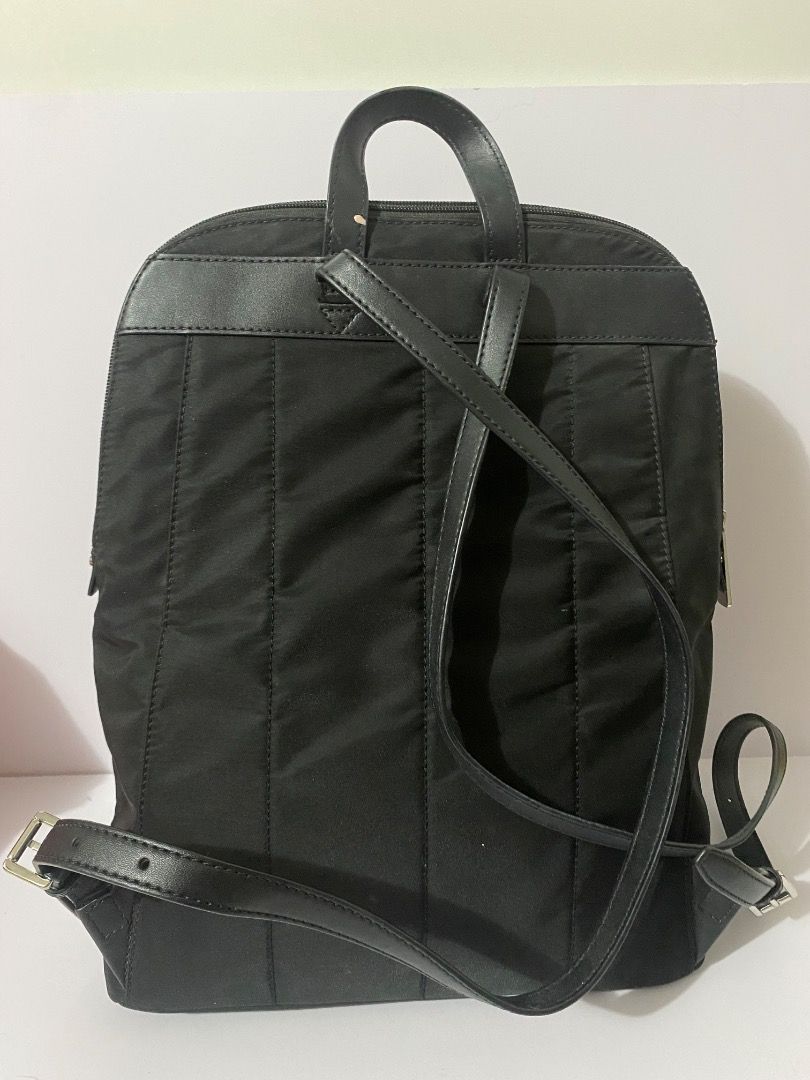 Michael Kors Black Nylon Backpack (Category: Backpacks) located in Caloocan City. Submitted by wrenessie (Listing ID 1459230141, Image 2). Description: - Brand: Authentic Michael Kors - Color: Black - Material: Nylon with leather trim - Closure: Zipper - Features: Adjustable straps, front zipper pocket - Condition: Clean inside and out - Ideal for: Everyday use - No flaws.