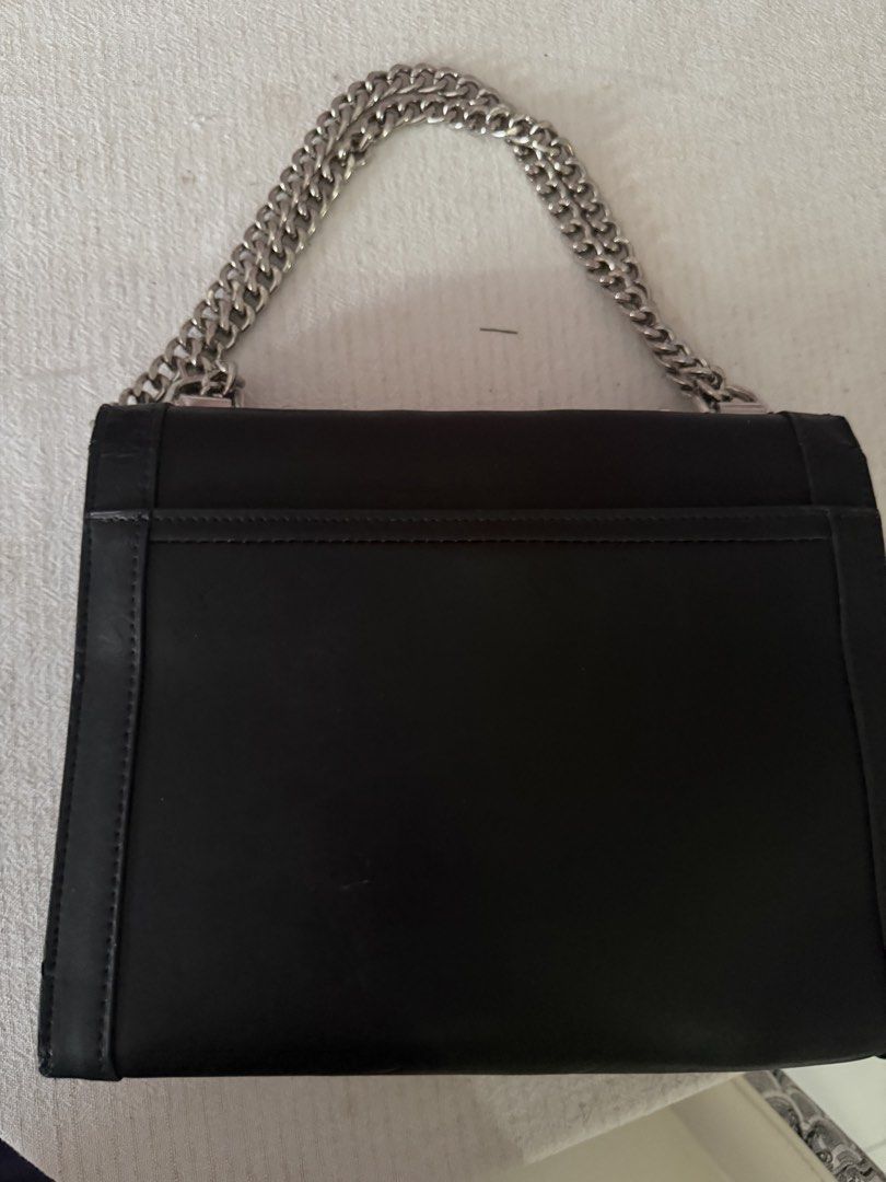 Michael Kors Black Studded Chain Shoulder Bag (Category: Luxury Bags & Wallets) located in Santa Rosa. Submitted by decluttering_. (Listing ID 1459101313, Image 3). Description: - RFS: decluttering - MOP: GCASH - MOD: Lalamove/Jnt - Authentic Michael Kors shoulder bag in black. - Eye-catching silver stud embellishments (stars & hearts) all over. - Stylish silver chain strap. - Secure turn-lock closure at the front. - Spacious interior with a zip 