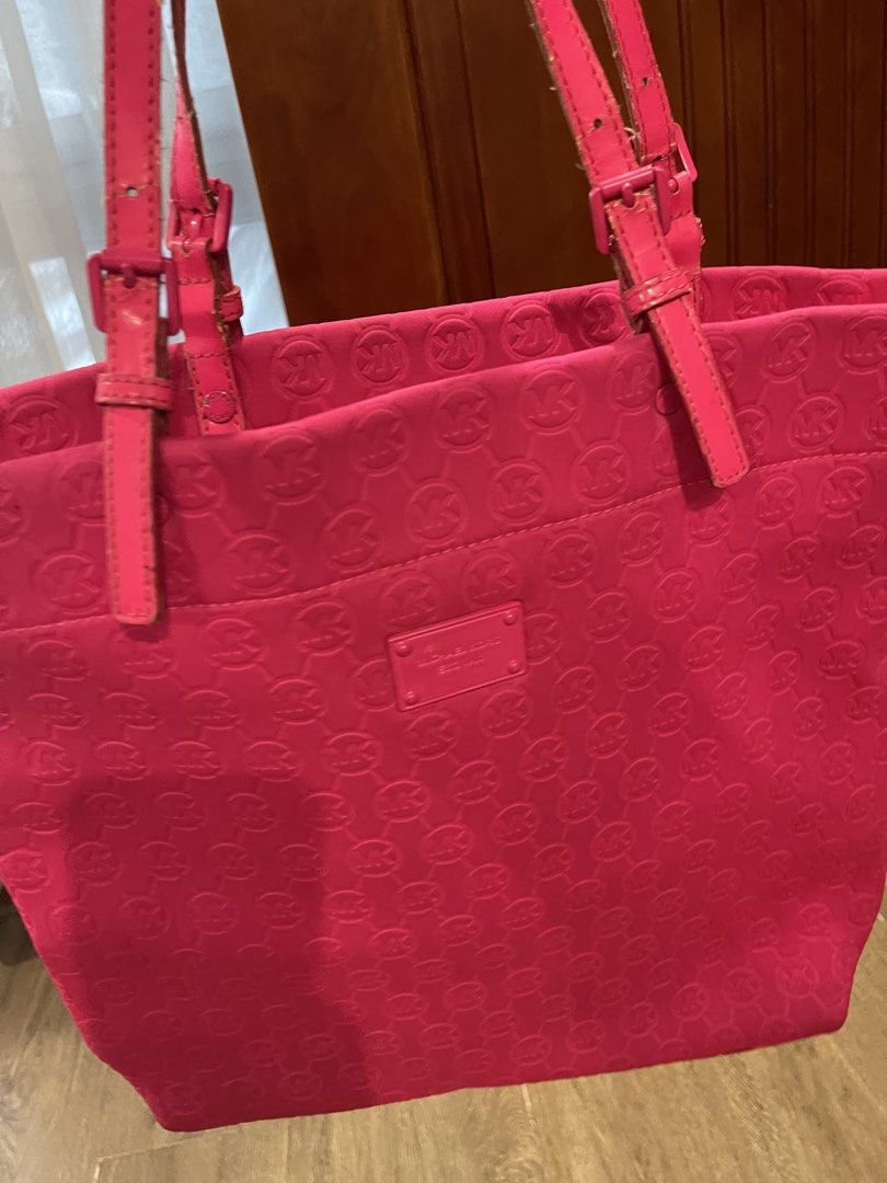 Michael Kors Pink Monogram Tote Bag (Category: Luxury Bags & Wallets) located in Quezon City. Submitted by anna_rl23 (Listing ID 1459088988, Image 3). Description: - Bright pink Michael Kors tote bag - All-over MK monogram pattern - Interior: 1 zip pocket, 2 slip pockets - Leather straps and trim - Perfect for everyday use or travel - Shows some signs of wear inside.