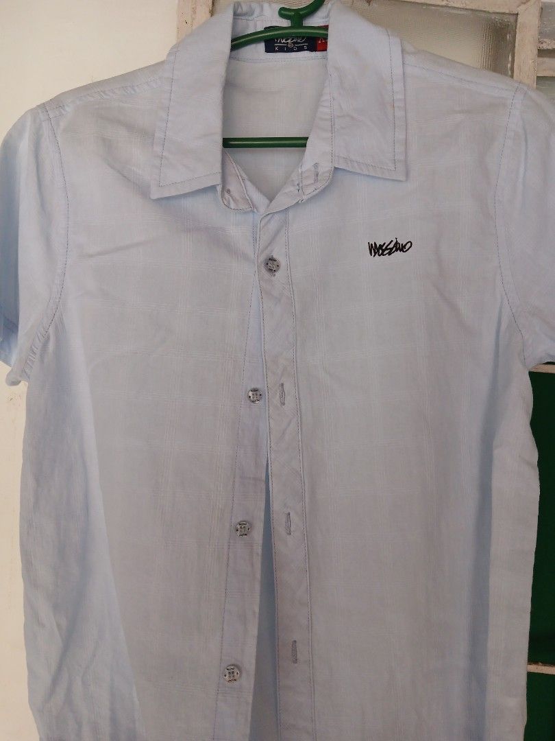 Mossimo Light Blue Short Sleeve Button Up Shirt (Category: Shirts) located in Makati City. Submitted by rbjoe17 (Listing ID 1459117781, Image 1). Description: - Mossimo short sleeve shirt - Light blue color - Button-up front - Embroidered Mossimo logo on chest - Versatile for casual or slightly dressed-up occasions.