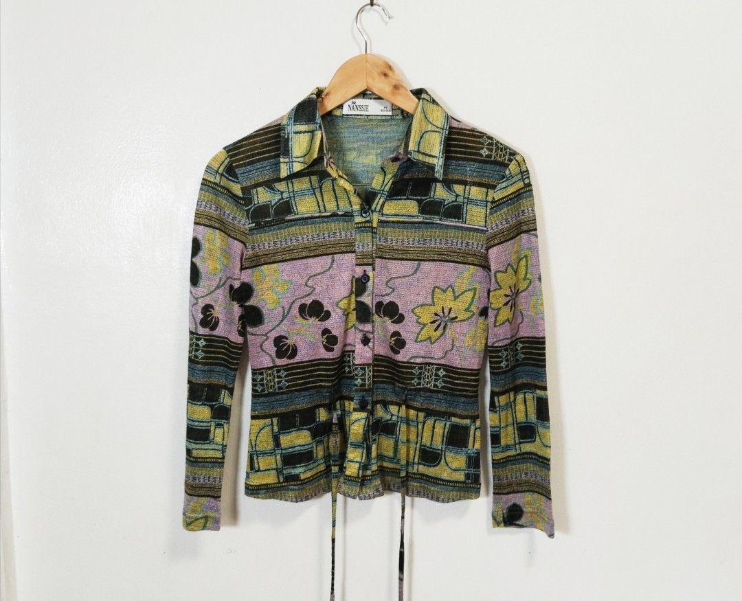 Nanssie Button-Up Long Sleeve Blouse Size M (Category: Blouses) located in Pateros City. Submitted by blashjunks.y2k (Listing ID 1459189929, Image 2). Description: - Nanssie brand blouse - Long sleeves - Collared neckline - Button-up front - Adjustable waist tie for a cinched look - Unique abstract and floral print - Perfect for dressing up or down.