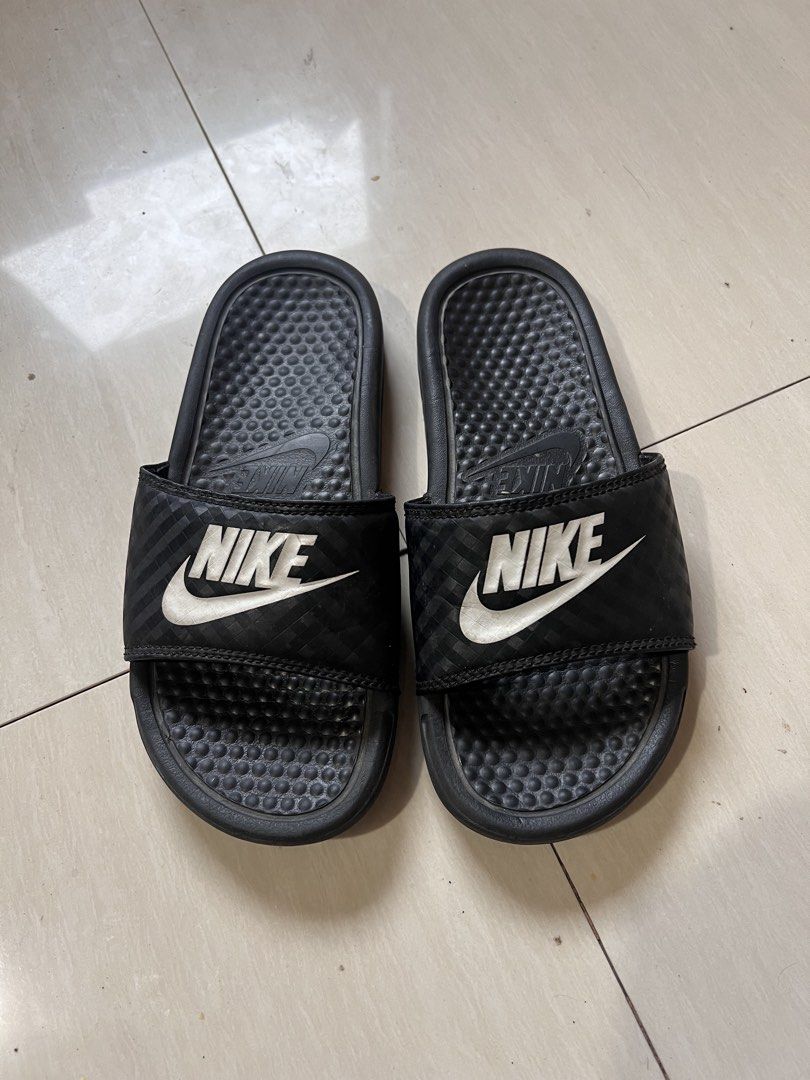 Nike Benassi Just Do It Slides Black White (Category: Slippers & Slides) located in Zamboanga. Submitted by safe.haimer (Listing ID 1459183205, Image 1). Description: - Brand: Nike - Model: Benassi Slides - Color: Black with White Nike Logo - Size: 36.5 EUR / 6 US - Features: Textured footbed for comfort - Ideal for: Casual wear, post-sport recovery.