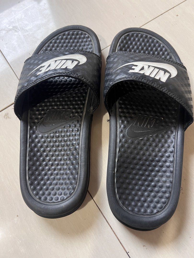 Nike Benassi Just Do It Slides Black White (Category: Slippers & Slides) located in Zamboanga. Submitted by safe.haimer (Listing ID 1459183205, Image 2). Description: - Brand: Nike - Model: Benassi Slides - Color: Black with White Nike Logo - Size: 36.5 EUR / 6 US - Features: Textured footbed for comfort - Ideal for: Casual wear, post-sport recovery.