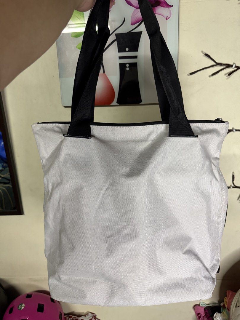 Nike Tote Bag (Category: Tote Bags) located in Taytay. Submitted by bellakutch (Listing ID 1459270222, Image 2). Description: - Chic two-tone Nike tote bag (black & white) - Secure zipper closure - Multiple interior compartments for organization - Ideal for gym sessions or everyday use - Constructed with durable materials.
