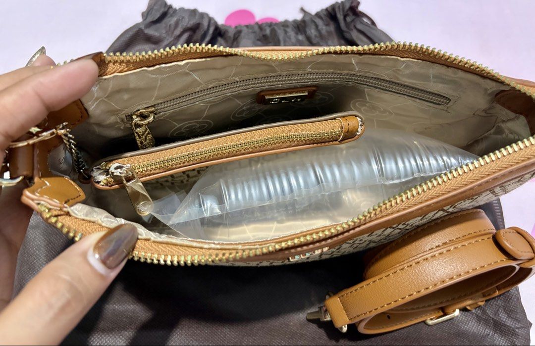 CLN Monogram Shoulder Bag with Detachable Strap (Category: Shoulder Bags) located in Caloocan City. Submitted by ms.maui (Listing ID 1459205595, Image 2). Description: - Stylish brown monogram shoulder bag - Tan leather trim and strap - Secure zipper closure - Interior zippered pocket and slip pocket - Detachable long strap included - Comes with a dust bag.