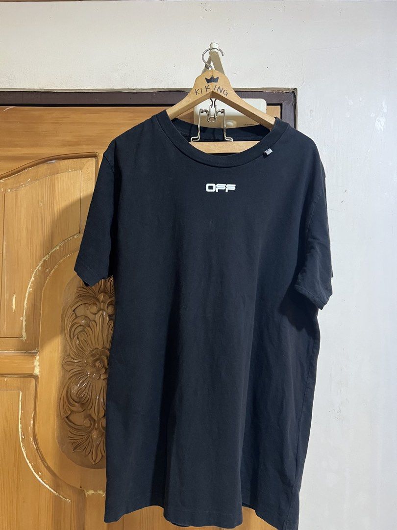 OFF-WHITE Black Graphic T-Shirt (Category: Tshirts & Polo Shirts ) located in Valencia. Submitted by thrifttomaniac_1225 (Listing ID 1459141391, Image 1). Description: - Authentic Black OFF-WHITE graphic t-shirt - Features the iconic OFF-WHITE arrows logo on the back - Unique painting-style graphic on the back - Small OFF-WHITE logo on the front chest - Essential addition to any streetwear collection.