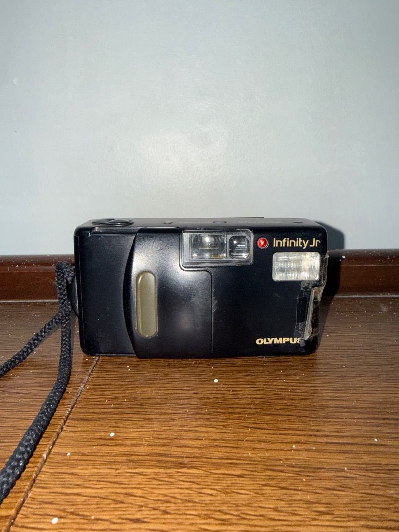 Olympus Infinity Jr (Category: Cameras) located in Caloocan City. Submitted by stevendgzmn (Listing ID 1459204878, Image 1). Description: Condition: * No film included * No battery included * Untested due to no battery/film * Shows signs of use, scratches, and cosmetic wear * Battery door has been secured with tape, as shown in the photos * Some wear and discoloration on the exterior * Lens and internal components are present * Functionality is n