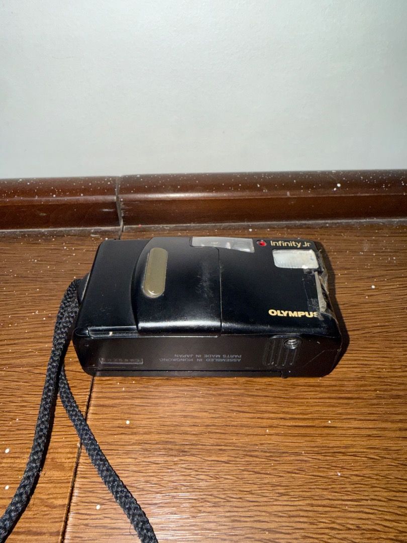 Olympus Infinity Jr (Category: Cameras) located in Caloocan City. Submitted by stevendgzmn (Listing ID 1459204878, Image 2). Description: Condition: * No film included * No battery included * Untested due to no battery/film * Shows signs of use, scratches, and cosmetic wear * Battery door has been secured with tape, as shown in the photos * Some wear and discoloration on the exterior * Lens and internal components are present * Functionality is n