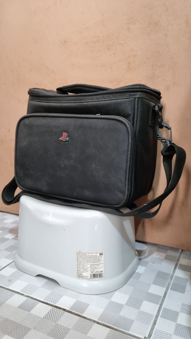 PlayStation 2 Slim Carrying Case (Category: Camera Bags & Carriers) located in Las Pinas. Submitted by rancorcoleski (Listing ID 1459146520, Image 1). Description: Early 2000s PS2 Slim Bag -Outer material of the bag is aged but no rips or missing parts. -Rubber PS emblem is intact and in good condition. -Strap included. -Games are not included but if you want to buy them, buy at your own risk. - Open for offers, let's talk. Terms & Conditions: No