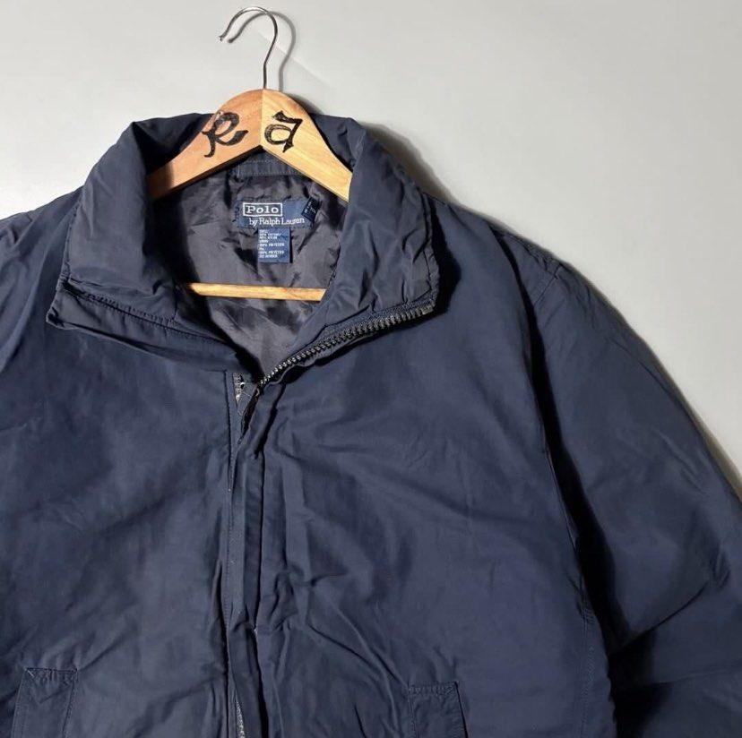 Polo Ralph Lauren Navy Blue Zip-Up Jacket (Category: Coats, Jackets and Outerwear) located in Quezon City. Submitted by dfgdam (Listing ID 1459109851, Image 2). Description: - Navy blue Polo Ralph Lauren jacket - Full zip-up front with stand-up collar - Two side pockets - Adjustable drawstring hem - Versatile for layering or standalone wear - Classic and timeless style .