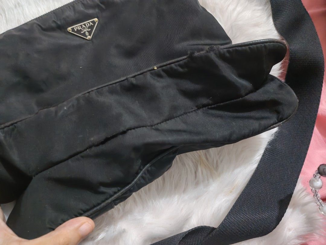 Prada Black Nylon Leather Trim Sling Bag (Category: Luxury Bags & Wallets) located in Quezon City. Submitted by preetycindz (Listing ID 1459102146, Image 3). Description: - Authentic Black Prada Sling Bag - Durable Nylon Material with Leather Trim - Adjustable Strap for Comfortable Wear - Secure Zipper Closure - Light-colored Interior Lining - Minor exterior marks, adding character - Ideal for Everyday Use.