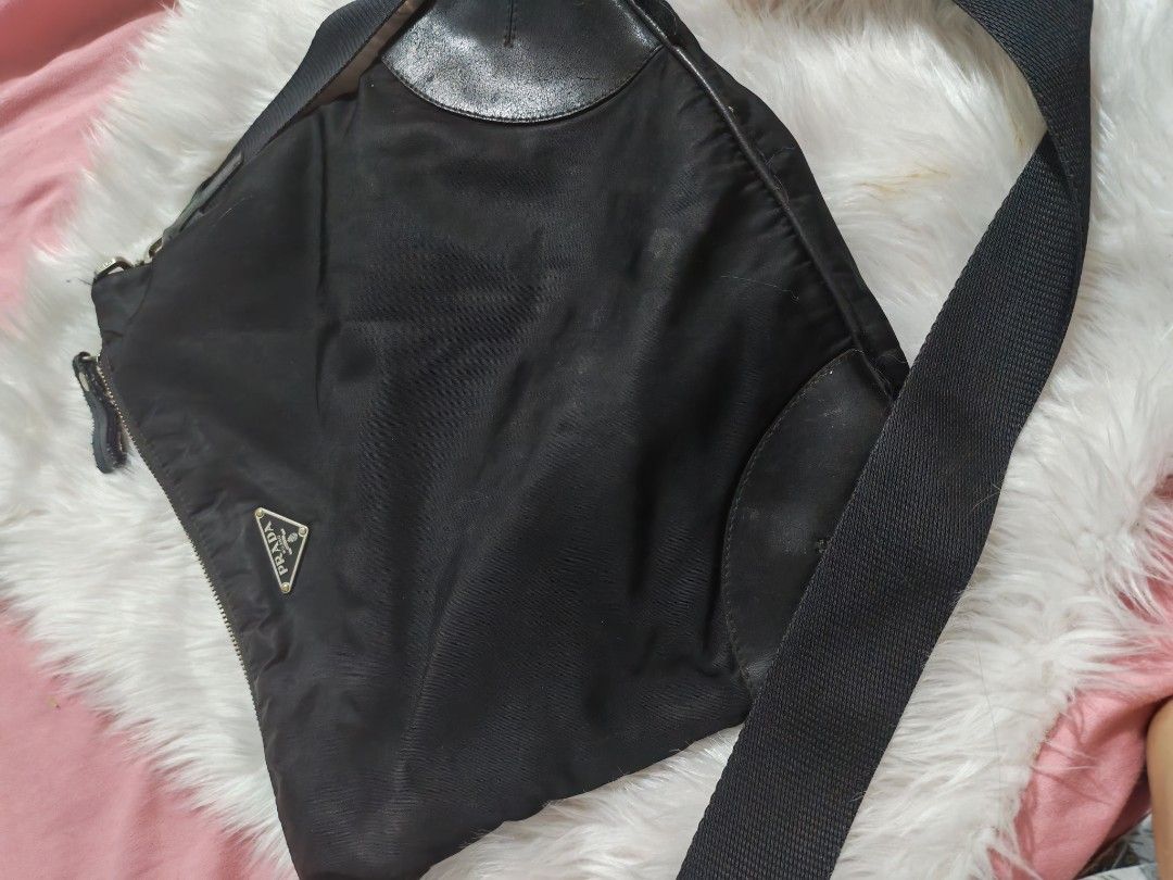 Prada Black Nylon Leather Trim Sling Bag (Category: Luxury Bags & Wallets) located in Quezon City. Submitted by preetycindz (Listing ID 1459102146, Image 2). Description: - Authentic Black Prada Sling Bag - Durable Nylon Material with Leather Trim - Adjustable Strap for Comfortable Wear - Secure Zipper Closure - Light-colored Interior Lining - Minor exterior marks, adding character - Ideal for Everyday Use.