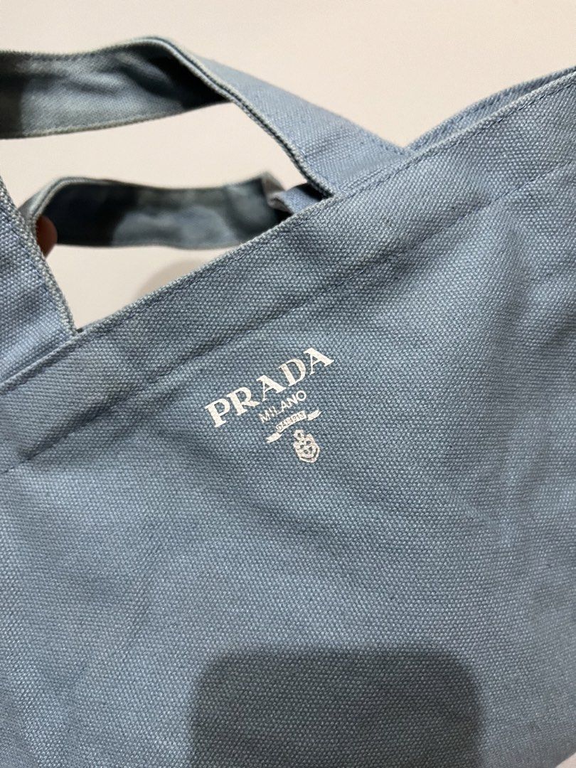 Prada Canvas Tote Bag (Category: Luxury Bags & Wallets) located in Manila. Submitted by jorgemabelin2001 (Listing ID 1459108449, Image 3). Description: - Light blue Prada canvas tote bag - Simple and classic design, perfect for everyday use - Features sturdy handles for durability - Iconic Prada logo printed on the front - Compact size, ideal for carrying your essentials.